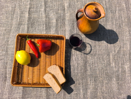 Red pepper, bread, and a jug on the table. High quality photoの写真素材