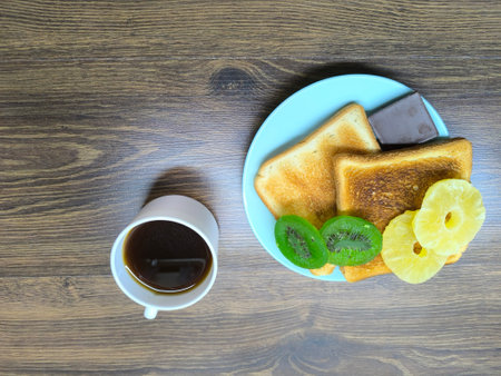 Black coffee in a cup and toast on a plate for breakfast. top view high-quality photoの写真素材
