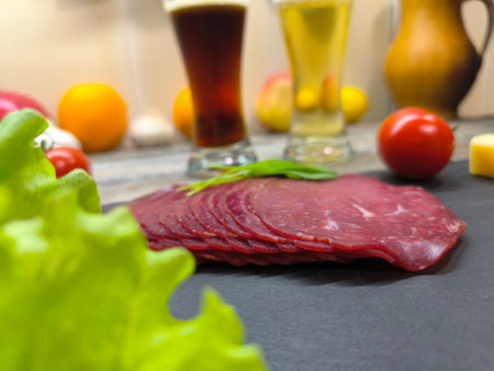 Thin slices of bacon lie on a sliced boardの写真素材