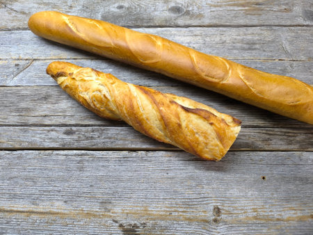 delicious pieces of baguette lie on a wooden tableの写真素材