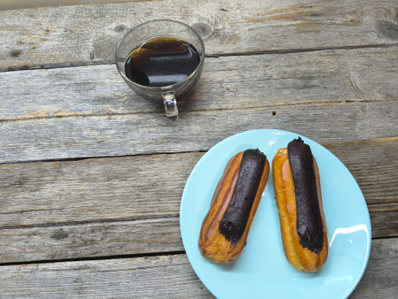 Eclairs on a plate close-up with chocolate
