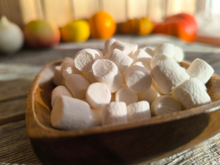 Beautiful, airy, pale white marshmallows on a wooden plate.の写真素材