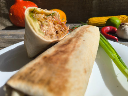 shawarma on a white plate surrounded by vegetables. photos in high qualityの写真素材
