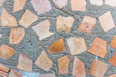 Texture of the rough, concrete wall containing a chaotic beaten brickの写真素材