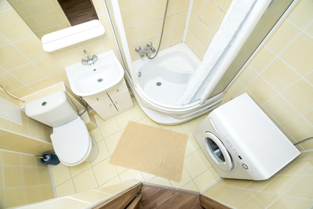 The photo of the light white bathroom with household appliances the top viewの写真素材