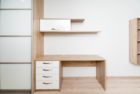 The photo of a wooden table and the shelf in the hotel roomの写真素材