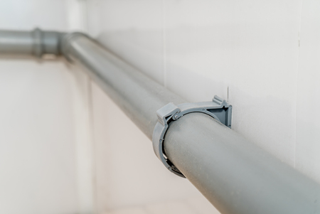 The photo of the established plastic pipes for water supply in the puplichny bathroomの写真素材