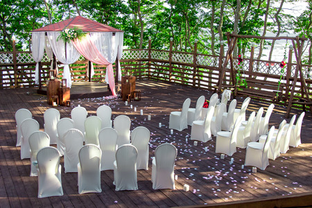 The photo of the decorated territory with chairs and a lodge for a weddingの写真素材