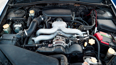 The photo of the automobile engine under a cowl close up