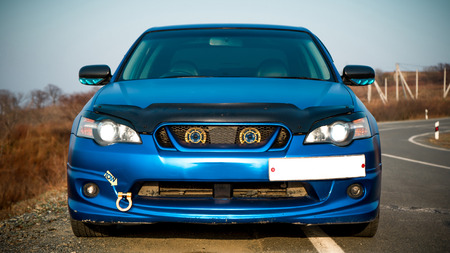 The photo of the blue car standing on the roadの写真素材
