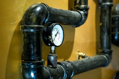 The photo of the established metal pipes for water supply with pressure sensorsの写真素材