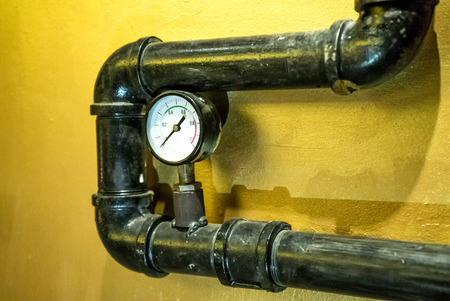 The photo of the established metal pipes for water supply with pressure sensors