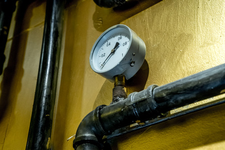 The photo of the established metal pipes for water supply with pressure sensors