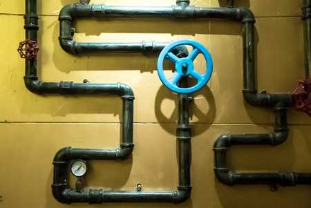 The photo of metal pipes for water supply with gate for opening and closingの写真素材
