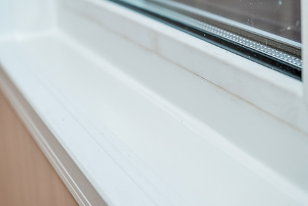 The photo of the established new white window sill indoors