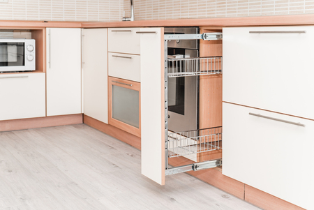 Photo of a kitchen sliding drying wooden cabinet close upの写真素材