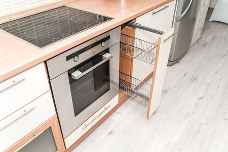 Photo of a kitchen sliding drying wooden cabinet close upの写真素材