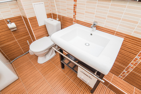 The photo of a white clean sink with the crane in the bathroomの写真素材