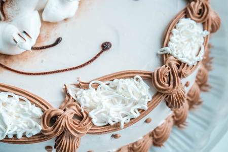 The photo of the white cake decorated cream close upの写真素材