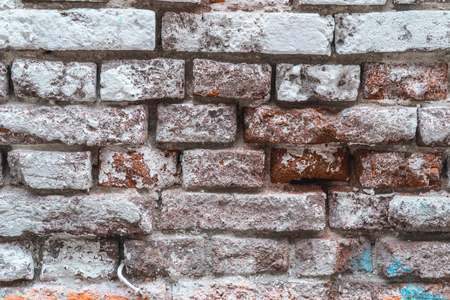 Texture of the old brick stylized wall with cracks close upの写真素材