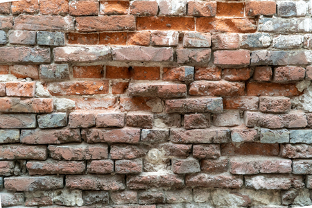 Texture of the old brick stylized wall with cracks close upの写真素材