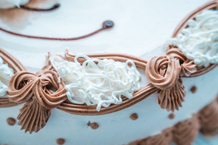 The photo of the white cake decorated cream close upの写真素材