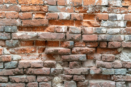 Texture of the old brick stylized wall with cracks close upの写真素材