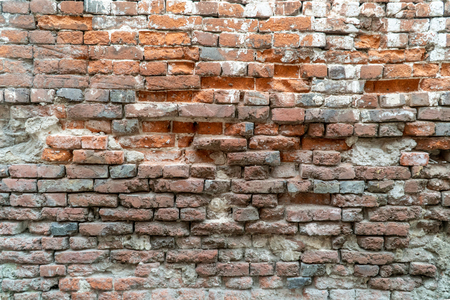 Texture of the old brick stylized wall with cracks close upの写真素材