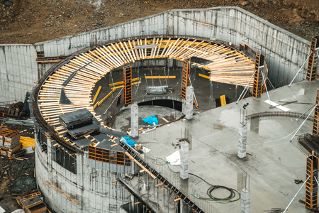 The photo of two buildings under construction standing on distance
