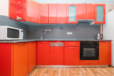 The photo of completely equipped light kitchen with household appliancesの写真素材