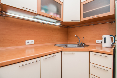 The photo of a white clean sink with the crane in the kitchenの写真素材