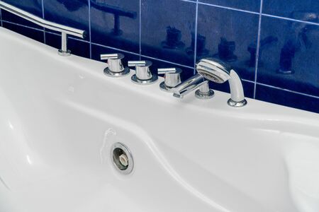 The photo of control levers of a hot tub in the bathroom