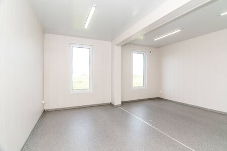 The photo of light white empty office room with bright lighting