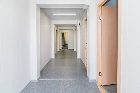 The photo of light white empty office room with bright lighting