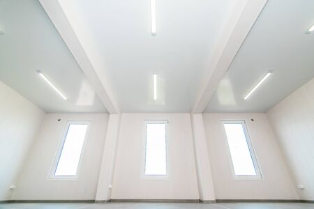 The photo of light white empty office room with bright lighting