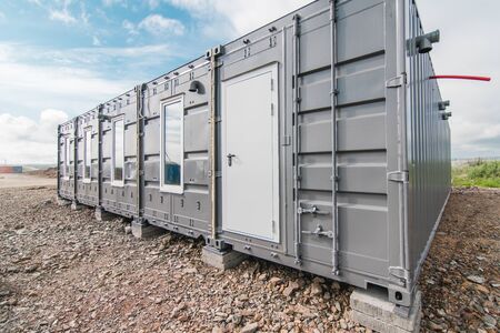 The photo of the house with windows and doors made of iron containers for cargo transportationの写真素材