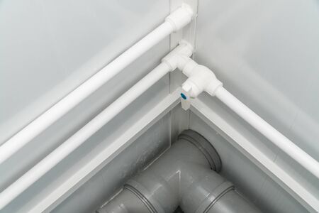 The photo of the established plastic pipes for water supply in the puplichny bathroomの写真素材