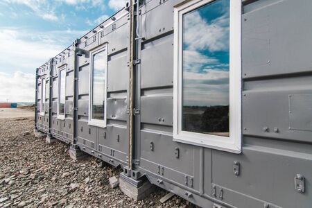 The photo of the house with windows and doors made of iron containers for cargo transportationの写真素材