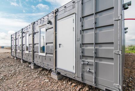 The photo of the house with windows and doors made of iron containers for cargo transportationの写真素材