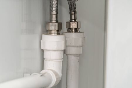 The photo of the established plastic pipes for water supply in the puplichny bathroomの写真素材