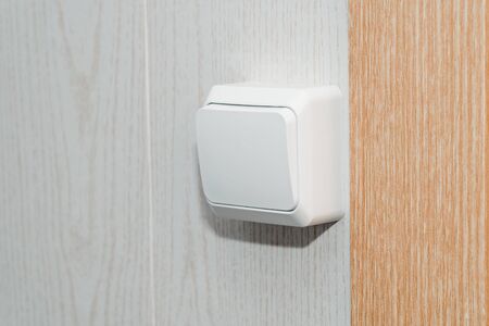 The photo of the white electric switch on a white wallの写真素材