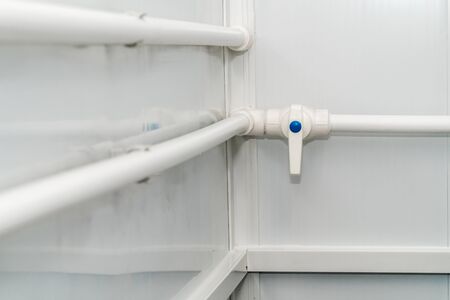 The photo of the established plastic pipes for water supply in the puplichny bathroomの写真素材