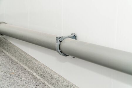 The photo of the established plastic pipes for water supply in the puplichny bathroomの写真素材