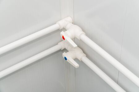 The photo of the established plastic pipes for water supply in the puplichny bathroomの写真素材