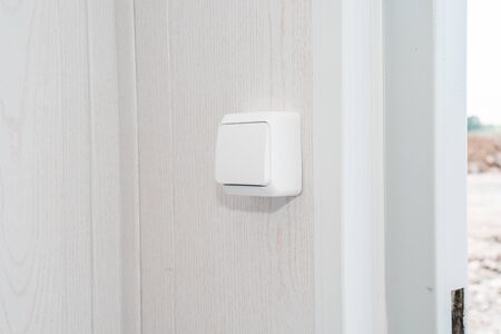 The photo of the white electric switch on a white wallの写真素材
