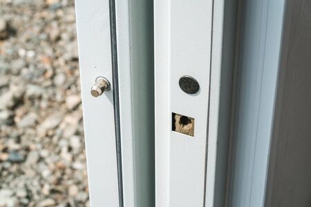 The photo of the white metal strengthened door with locksの写真素材
