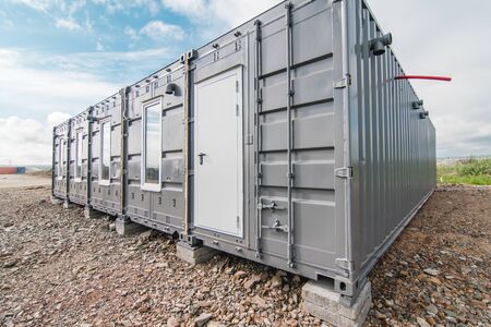 The photo of the house with windows and doors made of iron containers for cargo transportationの写真素材