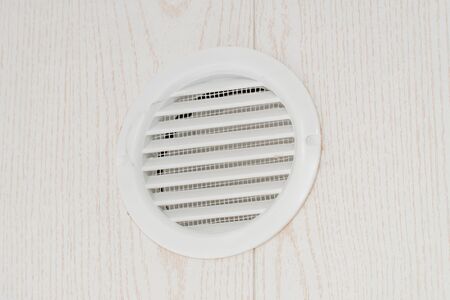 The photo of the fan on a white wall for air circulationの写真素材