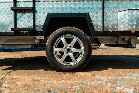 Photograph of truck with metal sides and wheels on cast discs close-upの写真素材
