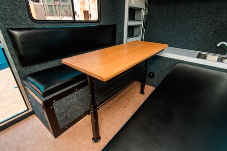 Photo of a small room with table, leather chairs and windowの写真素材